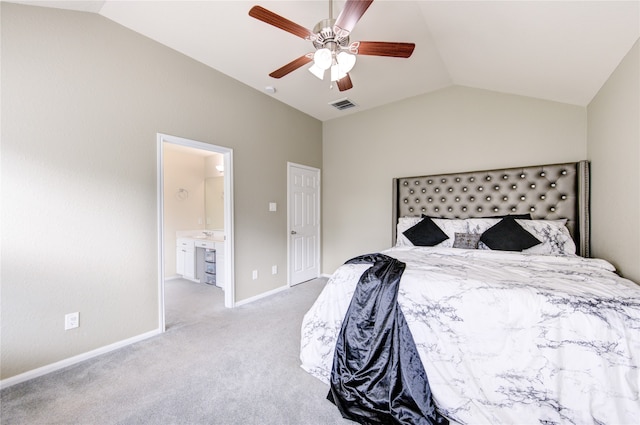 bedroom with light colored carpet, ceiling fan, vaulted ceiling, and connected bathroom