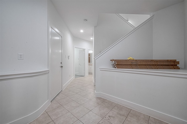 hall featuring light tile patterned floors