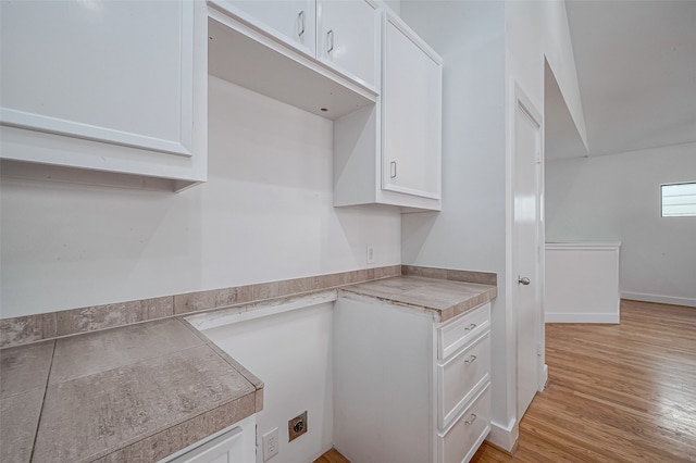 kitchen with white cabinetry and light hardwood / wood-style flooring