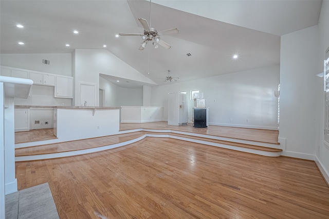 unfurnished living room with high vaulted ceiling, ceiling fan, and light hardwood / wood-style flooring