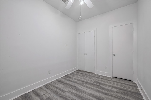 unfurnished bedroom featuring light wood-type flooring and ceiling fan