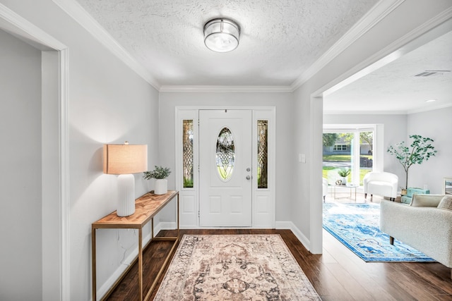 entrance foyer with dark wood-type flooring, a textured ceiling, and crown molding