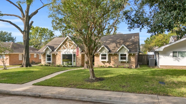 view of front of home with a front lawn and central AC unit