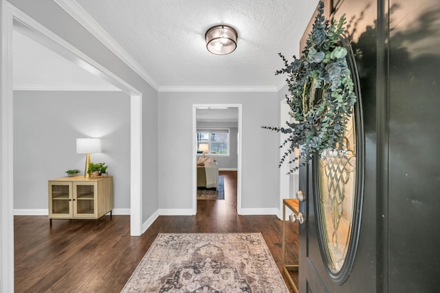 entryway featuring a textured ceiling, dark hardwood / wood-style floors, and crown molding