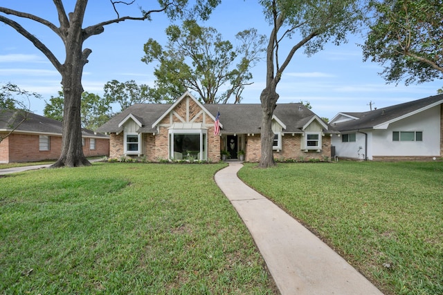 single story home featuring a front lawn