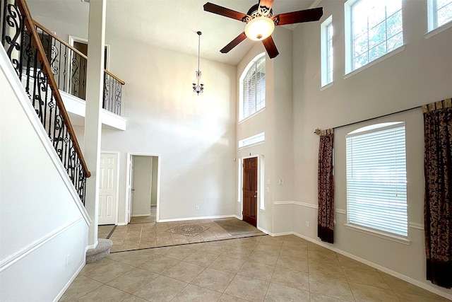 entryway with a high ceiling and light tile patterned floors