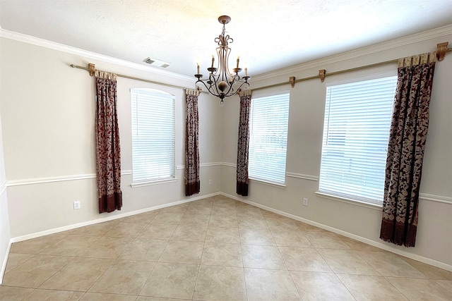 tiled empty room featuring a notable chandelier and crown molding