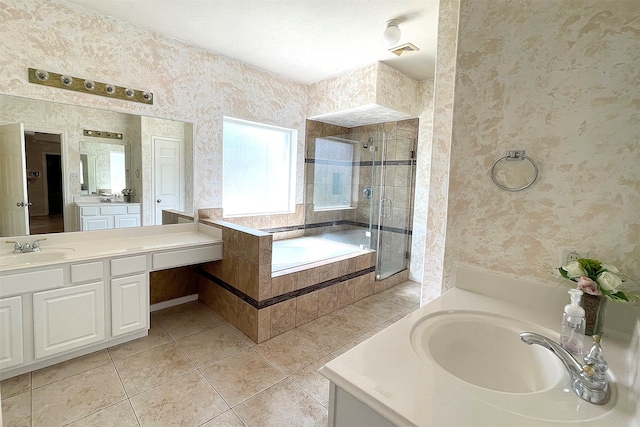 bathroom featuring shower with separate bathtub, vanity, and tile patterned floors