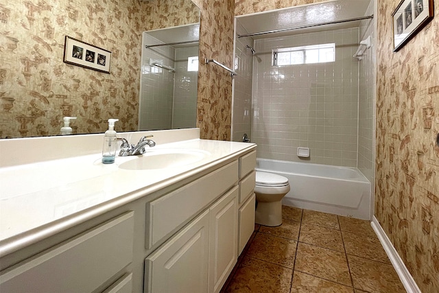 full bathroom with toilet, vanity, tiled shower / bath, and tile patterned floors