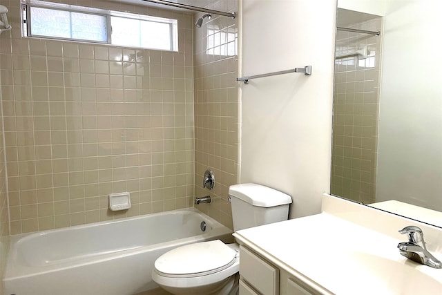 full bathroom featuring toilet, vanity, and tiled shower / bath