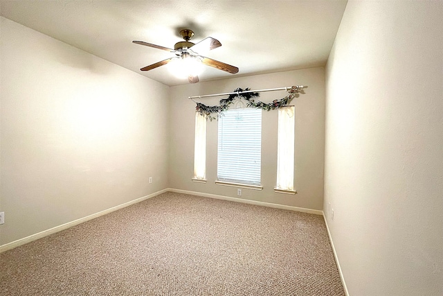 carpeted empty room featuring ceiling fan