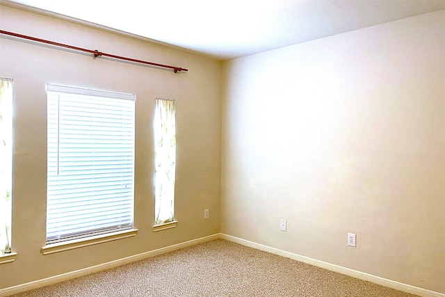 carpeted spare room with a wealth of natural light