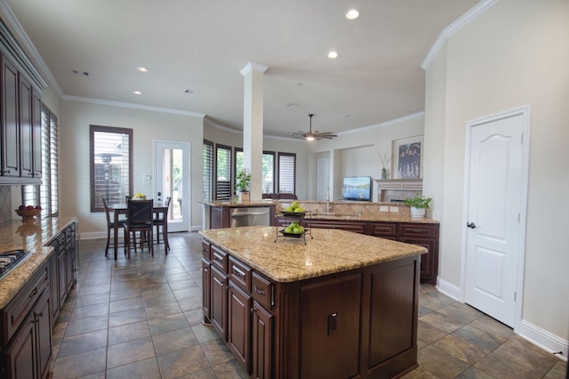 kitchen with dishwasher, a center island, ceiling fan, and a healthy amount of sunlight