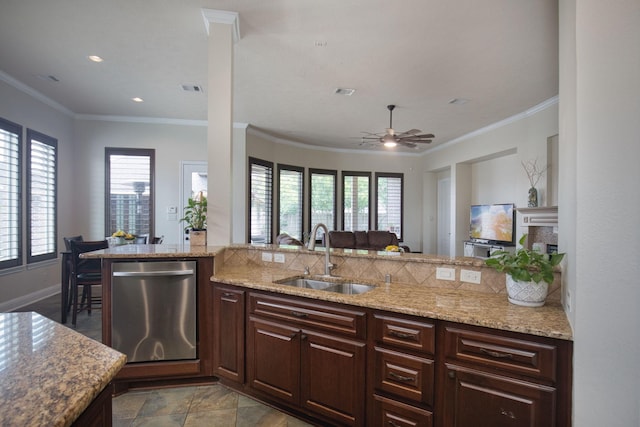 kitchen featuring stainless steel dishwasher, a wealth of natural light, crown molding, and sink