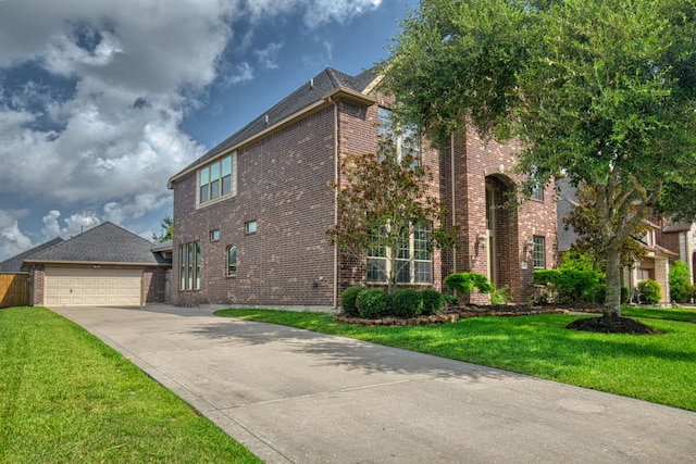 view of front of property with a front yard and a garage