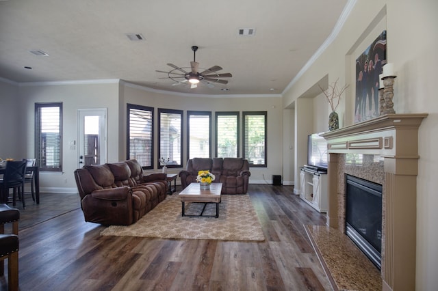 living room with hardwood / wood-style floors, plenty of natural light, ornamental molding, and ceiling fan