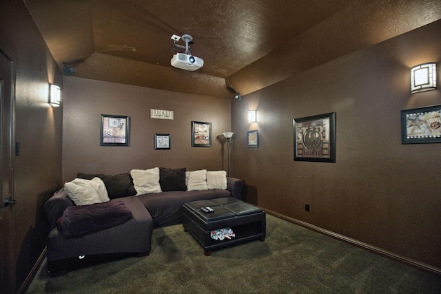 carpeted home theater room featuring vaulted ceiling