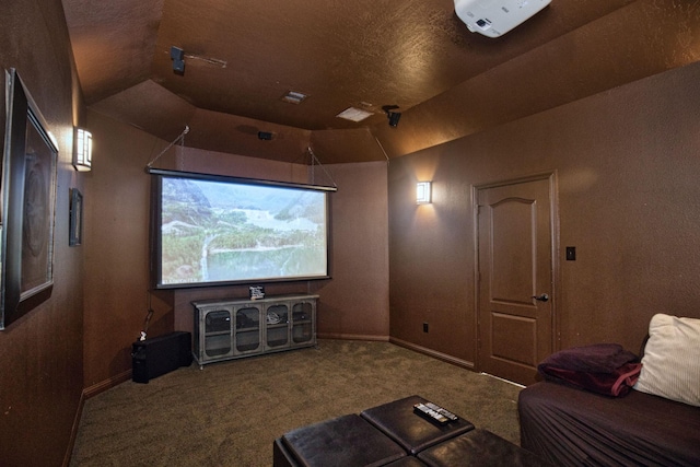 carpeted home theater with lofted ceiling and a textured ceiling