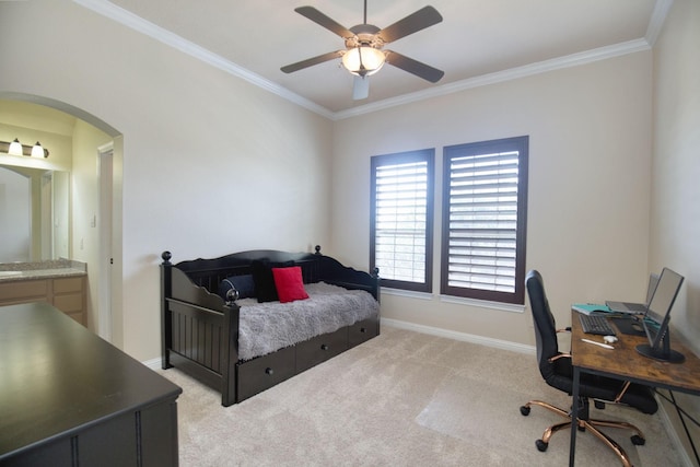 bedroom with ceiling fan, light colored carpet, crown molding, and ensuite bath