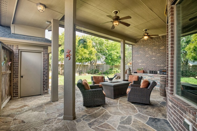 view of patio with a fire pit and ceiling fan