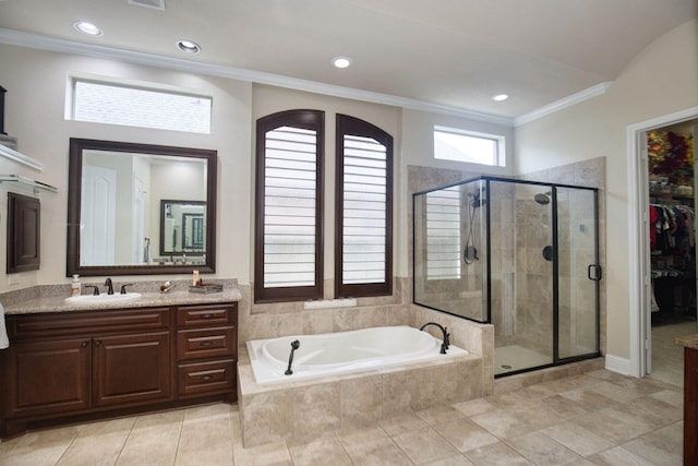 bathroom featuring tile patterned flooring, vanity, ornamental molding, and shower with separate bathtub