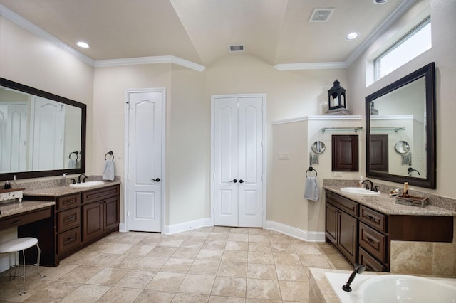 bathroom with tile patterned floors, a bathtub, vanity, and ornamental molding