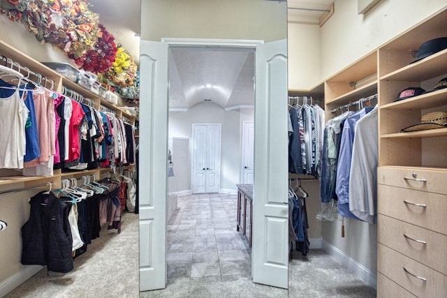 walk in closet with lofted ceiling