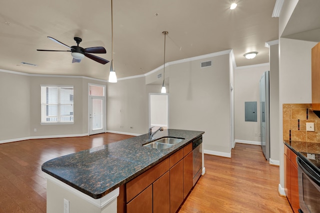 kitchen with ornamental molding, light wood-type flooring, appliances with stainless steel finishes, hanging light fixtures, and sink