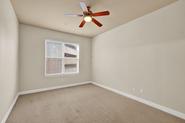 spare room featuring carpet floors and ceiling fan