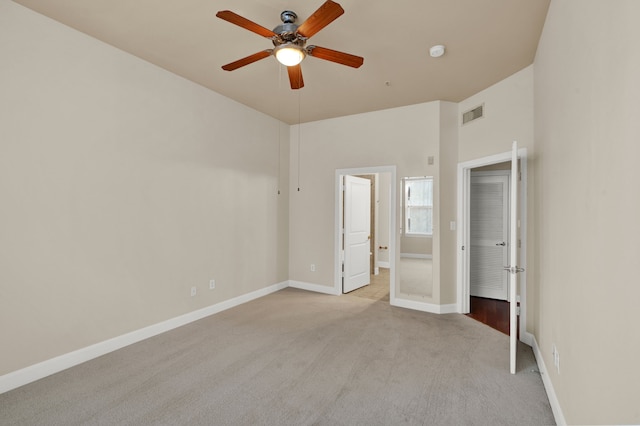 unfurnished bedroom with light colored carpet and ceiling fan