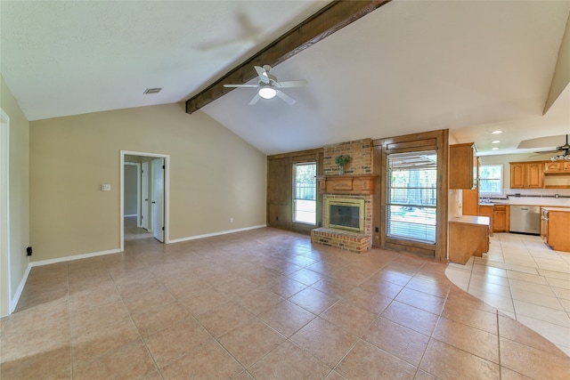 unfurnished living room featuring ceiling fan, light tile patterned floors, vaulted ceiling with beams, and a brick fireplace