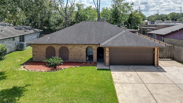 view of front of home with a garage, central AC, and a front lawn