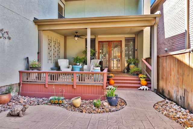 entrance to property with covered porch and ceiling fan