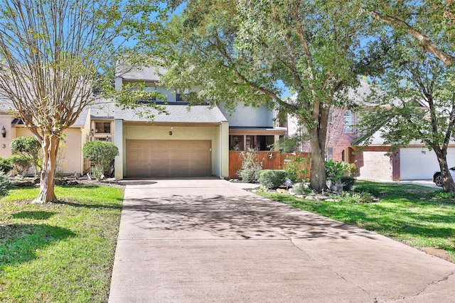 view of front of property featuring a garage and a front yard