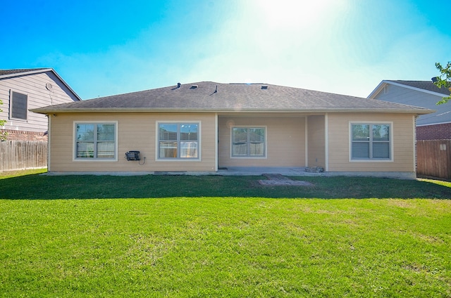 back of house with a lawn