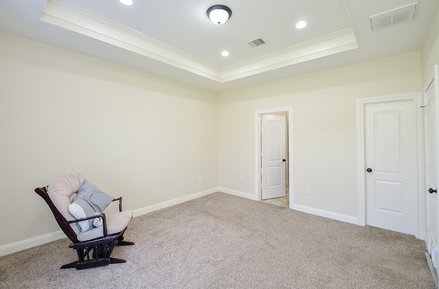 unfurnished room featuring light colored carpet, ornamental molding, and a tray ceiling