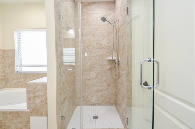 bathroom featuring shower with separate bathtub