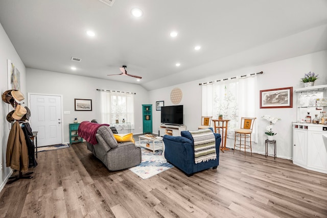 living room featuring light hardwood / wood-style floors, lofted ceiling, and ceiling fan