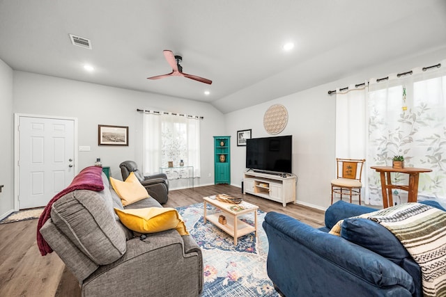 living room featuring lofted ceiling, wood-type flooring, and ceiling fan