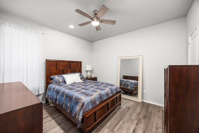 bedroom featuring light hardwood / wood-style floors and ceiling fan