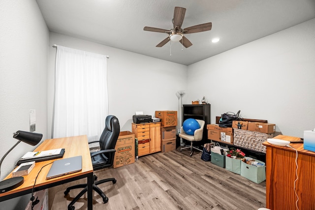 office space with wood-type flooring and ceiling fan