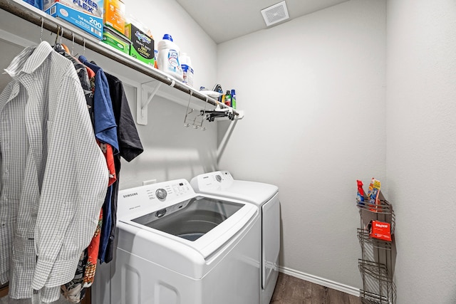 laundry room featuring dark wood-type flooring and separate washer and dryer