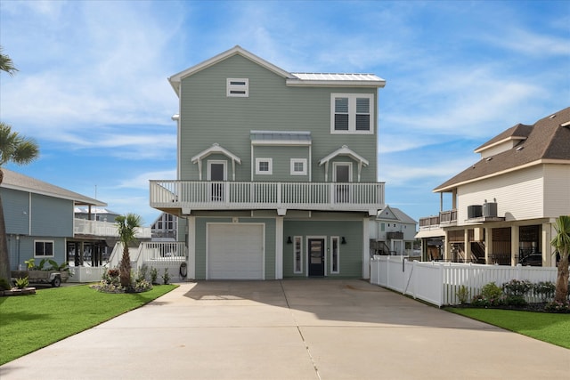 view of front of home with a balcony, a garage, and a front lawn