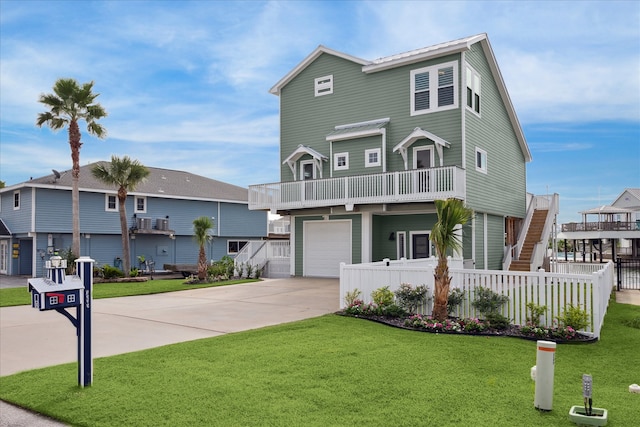 view of front facade with a balcony, a front lawn, and a garage