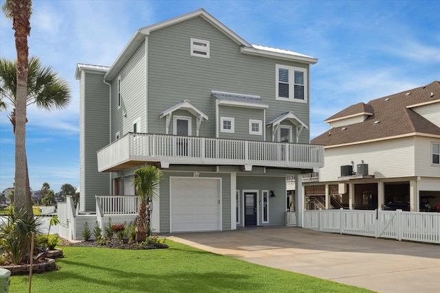 view of front of property featuring central AC, a balcony, a garage, and a front lawn