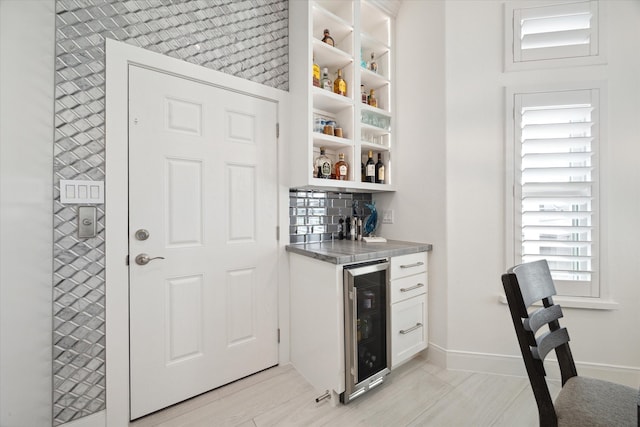 bar with wine cooler and white cabinets