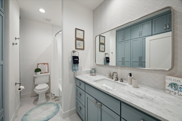 full bathroom with vanity, tile patterned floors, toilet, tile walls, and shower / tub combo with curtain