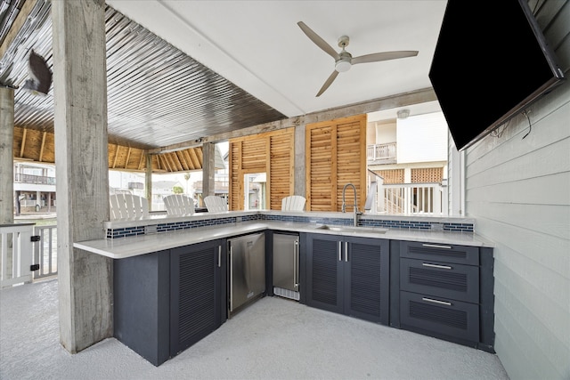 view of patio / terrace with an outdoor kitchen, ceiling fan, and sink