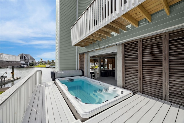 wooden terrace featuring a water view