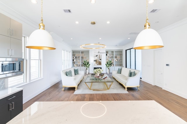 living room featuring hardwood / wood-style floors and ornamental molding